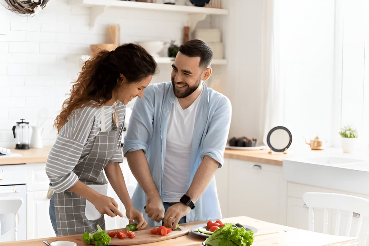 Greek-Inspired Cooking at Home Couple preparing Greek-inspired recipes together in a bright kitchen